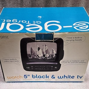 May include: A black and white 5-inch portable TV in its original box. The box is blue and white with the text "e-gear at Target". The TV screen displays a black and white image of sailboats. The box also states it has audio and video input jacks and a built-in carrying handle.
