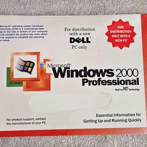 May include: A Microsoft Windows 2000 Professional Quick Start Guide. The cover is white with red accents and features the Windows logo and Dell branding. Text includes "Essential Information for Getting Up and Running Quickly."