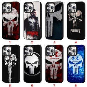 Peut inclure: Huit coques de téléphone avec des motifs de crânes. Les coques présentent différents coloris, dont le rouge, le blanc, le noir et le bleu. Certaines coques affichent le mot "Punisher" ou le logo Under Armour.