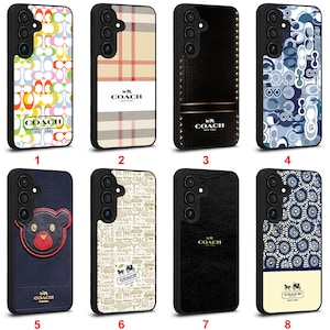 May include: Eight phone cases with diverse designs are displayed. The cases feature patterns like floral, plaid, and logo designs. The Coach logo is visible on several cases. The cases are black with different colored designs. The cases are for a mobile phone.
