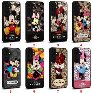 May include: Eight black phone cases showcasing Disney's Mickey and Minnie Mouse. Designs vary, incorporating floral backgrounds, Coach branding, and different character illustrations. Each case has a unique look.