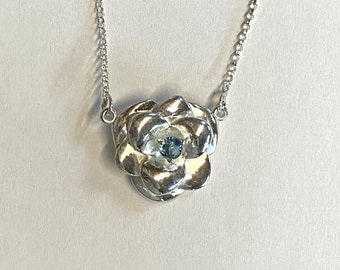 Ladies Rose Shaped Pendant on 16" Chain Set with 3.5mm Blue Topaz Gemstone