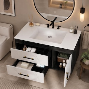 May include: A bathroom vanity featuring a dark wood cabinet with two white marble-patterned drawers and a side cabinet door, all equipped with black and gold handles. The vanity includes a white countertop, a rectangular sink, and a black faucet.