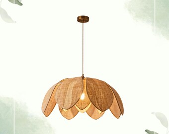 May include: A pendant light fixture with a flower-like shade. The shade is made of woven, light brown material, with a darker brown metal canopy and a thin, brown cord. The light bulb is visible inside the shade.