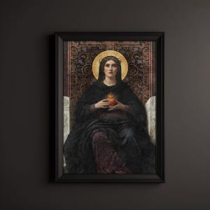 May include: A framed artwork depicting a religious figure with a golden halo and a crown of thorns. The figure is wearing dark robes and holding a glowing heart. The background has ornate patterns, and the artwork is in a black frame.