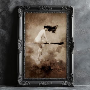 May include: A framed sepia print shows a nude figure on a broom against a cloudy backdrop. The black frame features decorative detailing. The artwork has a vintage, gothic style, ideal for wall decor.