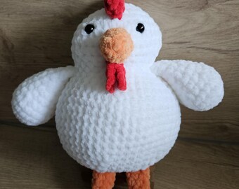 May include: A handmade white plush chicken with orange legs and a red comb and wattle. The chicken has black eyes and small wings. This soft toy is a cute and cuddly farm animal.