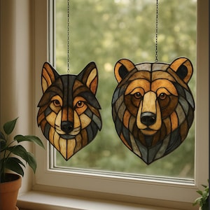 May include: Two stained glass window hangings, one depicting a wolf and the other a bear, both featuring intricate geometric patterns in brown, black, and gold. Each is suspended by a chain, creating a decorative woodland theme.