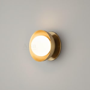 Luxury brass globe wall sconce emitting warm ambient light
