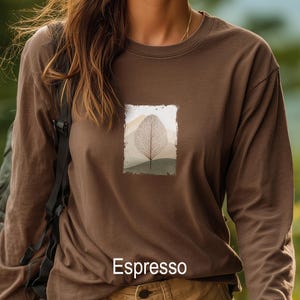 May include: Espresso-colored long-sleeve shirt with a rectangular graphic of a leaf and mountain landscape. The shirt is a solid brown color with the word "Espresso" printed at the bottom.