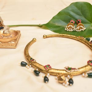 Royal handmade gold toned Rajasthani themed hasli with Jumkas . Unique handcrafted traditional elegance. Vintage and Festrive collection.