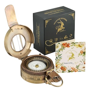 May include: A vintage brass compass with a hinged lid, open to reveal the compass face. The compass is accompanied by a black gift box and a floral card, both with the text "Houston Souvenir" and "Gift of Love".