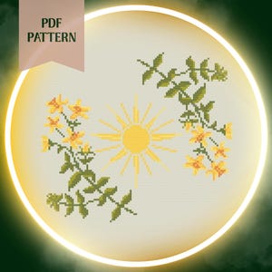 May include: A cross-stitch design with a yellow sun and floral details. The pattern shows yellow flowers and green leaves framing the sun. The words "PDF PATTERN" are displayed in a banner at the top of the image.