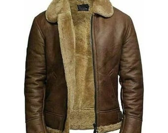 May include: A brown leather jacket with a shearling lining and collar. The jacket has a full-length zipper and a classic aviator style. The sleeves and hem are trimmed with shearling. A warm and stylish outerwear option.