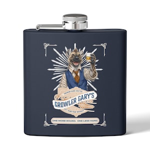 May include: Navy blue flask with a silver cap featuring a cartoon hyena holding a whiskey glass. The flask has the text "Growler Gary's Left Hand Pour Whiskey" and "One More Round. One Less Hand."