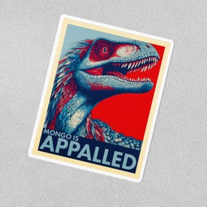 May include: A sticker featuring a stylized dinosaur illustration. The dinosaur is primarily blue with red accents, set against a red and blue background. The text "MONGO IS APPALLED" is displayed in bold, dark blue letters.