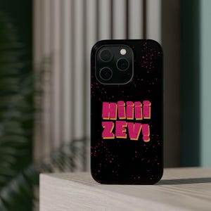 May include: A black smartphone case featuring a speckled pattern of small pink dots. The center of the case displays the text HIIII ZEV! in bold, pink, block-style letters with a yellow drop shadow, set against the dark, textured background.