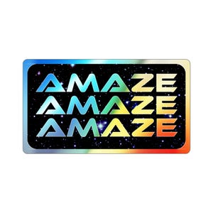 May include: A rectangular sticker with the word "AMAZE" repeated three times in a gradient of colors. The background is black with white stars, and the border has a rainbow gradient.