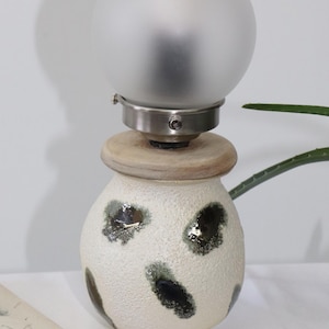 Textured Ceramic Globe Lamp with Metallic Accents and Frosted Glass