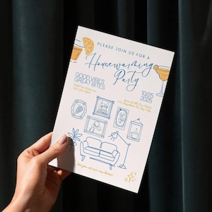 May include: A white invitation card with blue illustrations and text for a housewarming party. The card features drawings of a cocktail, furniture, and framed pictures. Text includes "Housewarming Party", "Good Vibes Great Bites", and the date.