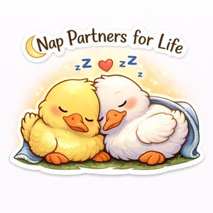 May include: A sticker featuring two cartoon ducks napping together. One is yellow, the other white, both with closed eyes and orange beaks. The text "Nap Partners for Life" arches above them, with a crescent moon and heart graphic.