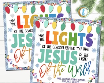 May include: A printable Christmas card with a festive design featuring colorful light bulbs and the message "May the lights of the season remind you that Jesus is the light of the world". The card also includes the text "Have a blessed holiday season, Love, Mrs. Jackson".