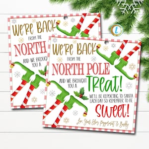 May include: Two printable Christmas elf gift tags with a red and white gingham background. The tags feature a green elf with red and white striped legs and a gold bell. The text on the tags reads "We're back from the North Pole and we brought you a Treat! We'll be reporting to Santa each day so remember to be Sweet! Love, Your Elves Peppermint & Buddy."