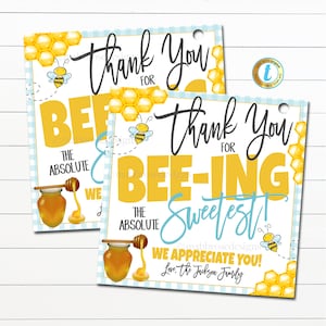 May include: Two yellow and blue thank you tags with a bee and honey pot design. The text reads "Thank you for bee-ing the absolute sweetest! We appreciate you! Love, the Jackson Family."