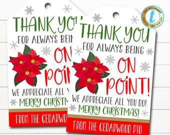 May include: Two white gift tags with red poinsettia flowers and snowflakes. The text on the tags reads "Thank you for always being on point! We appreciate all you do! Merry Christmas! From the Cedarwood PTO".
