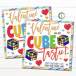 May include: Two Valentine's Day cards with colorful text and Rubik's Cube illustrations. The cards read "Valentine, Cube-tastic!" with hearts and the message "Happy Valentine's Day from your friend Jane."