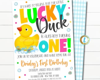 May include: A colorful birthday invitation for a first birthday party. The invitation features a yellow rubber duck with the text "Lucky Duck is already turning one!" in bright colors. The invitation also includes the child's name, the date and time of the party, and the location.