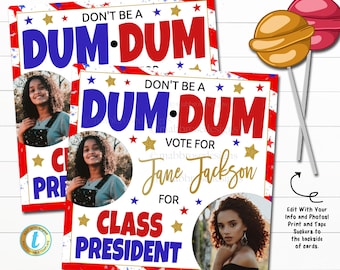 May include: Two red, white, and blue election campaign signs with a photo of a young woman and the text "Don't be a Dum-Dum Vote for Jane Jackson for Class President".