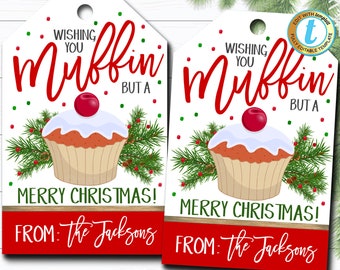 May include: Two white gift tags with red and green Christmas decorations. The tags feature a red cupcake with white frosting and a cherry on top. The text on the tags reads "Wishing you muffin but a Merry Christmas! From: The Jacksons".