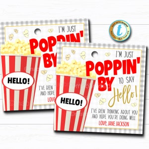 May include: Two printable gift tags featuring a red and white striped popcorn bucket with the text "I'm just poppin' by to say hello!" and "I've been thinking about you and hope you're doing well. Love, Jane Jackson."