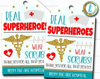 May include: Two printable gift tags with a teal, white, and gold design. The tags feature a gold caduceus symbol, a red heart with a white cross, and the text "Real Superheroes Wear Scrubs!"  Thank you for all that you do! From the ABC Hospital.