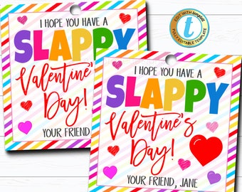 May include: Two Valentine's Day gift tags with colorful text and heart illustrations. The tags read "I HOPE YOU HAVE A SLAPPY Valentine's Day!" and "YOUR FRIEND". One tag includes "YOUR FRIEND, JANE". The tags have a rainbow striped border.