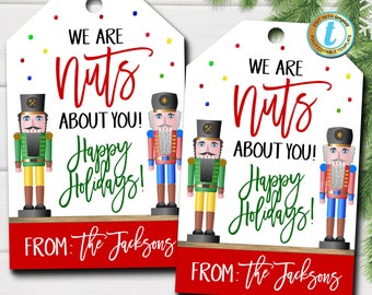 May include: Two white gift tags with a red and green nutcracker illustration. The text on the tags reads "We are nuts about you! Happy Holidays! From: The Jacksons".