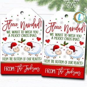 May include: Two white sheep wearing Santa hats with red and white trim, with a green holly sprig between them. The text "Fleece Navidad!" is at the top of the tag, with the text "We want to wish you a Merry Christmas" below. The text "From the bottom of our hearts!" is below the sheep, and the text "FROM: The Jacksons" is at the bottom of the tag.