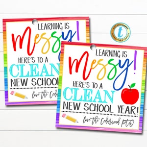 May include: Two colorful printable gift tags with a rainbow background. The text on the tags reads "Learning is messy! Here's to a clean new school year!" and "love the Cedarwood PTO".