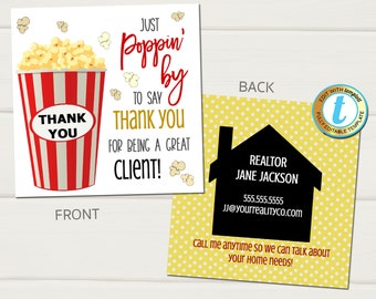 May include: A thank you card with a red and white striped popcorn bucket with yellow popcorn. The text on the card reads "Just Poppin' by to say Thank You for being a great client!" The back of the card has a yellow background with white polka dots and a black silhouette of a house with the text "Realtor Jane Jackson 555.555.5555 JJ@yourrealtyco.com Call me anytime so we can talk about your home needs!"