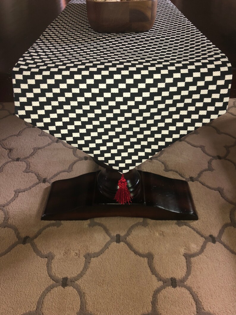 Modern black and white zigzag Christmas tree skirt with red trim