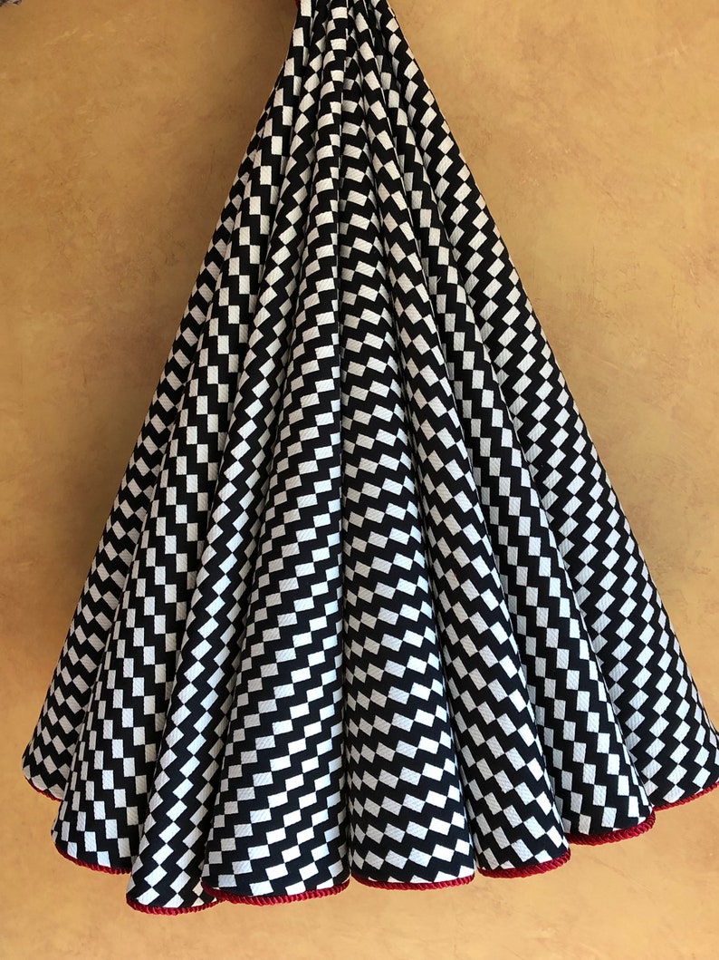 Modern black and white zigzag Christmas tree skirt with red trim