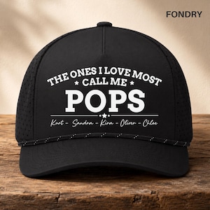 May include: Black baseball cap with white text that reads "THE ONES I LOVE MOST CALL ME POPS" with names below. The cap has a mesh back and a rope detail on the brim. The brand name "FONDRY" is in the top right corner.