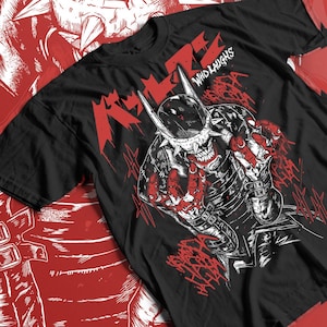 May include: Black t-shirt with a red and white graphic design. The design features a skull-like character with sharp teeth and a spiked helmet. The text "WHO LAUGHS" is above the character, and the word "LAUGHS" is in a stylized font.