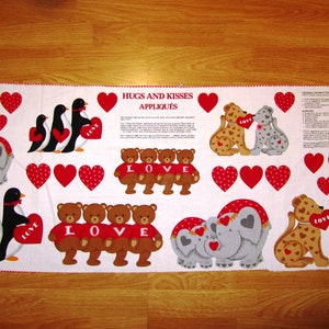 May include: A white fabric panel with red hearts and applique designs of penguins, elephants, bears, and leopards. The fabric panel features the text "Hugs and Kisses Appliques".