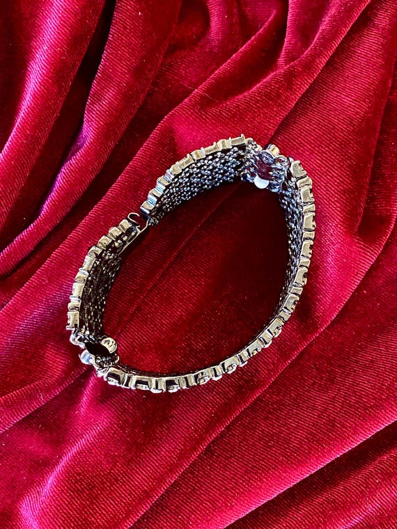 A wide cuff bracelet with multiple rows of clear … - image 9