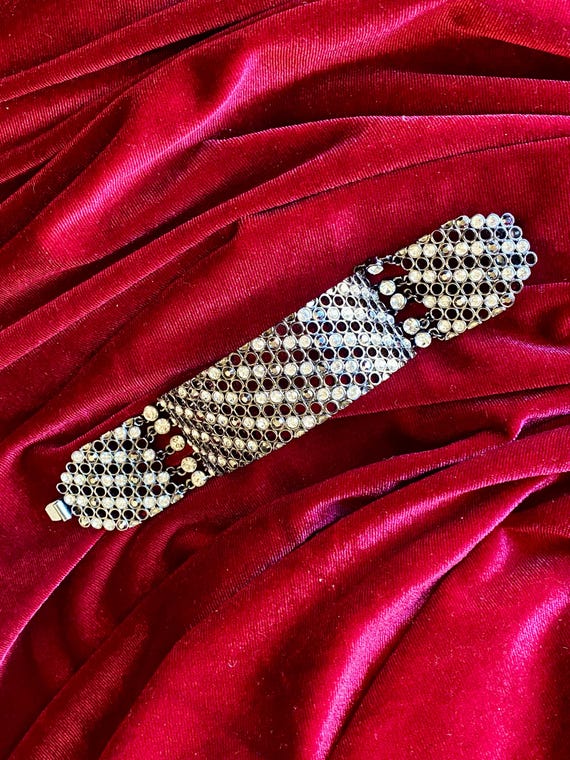 A wide cuff bracelet with multiple rows of clear … - image 6