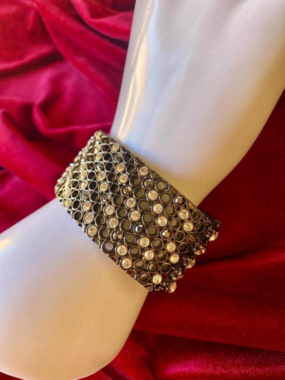A wide cuff bracelet with multiple rows of clear … - image 2