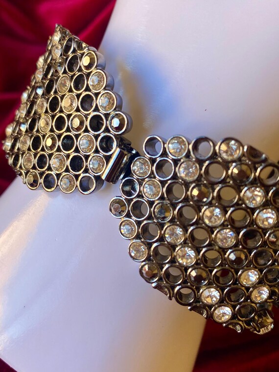 A wide cuff bracelet with multiple rows of clear … - image 5