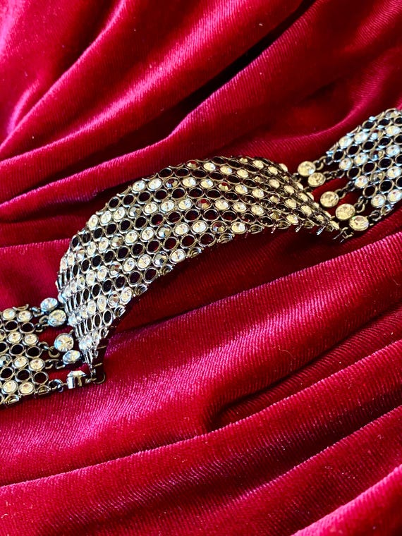 A wide cuff bracelet with multiple rows of clear … - image 7